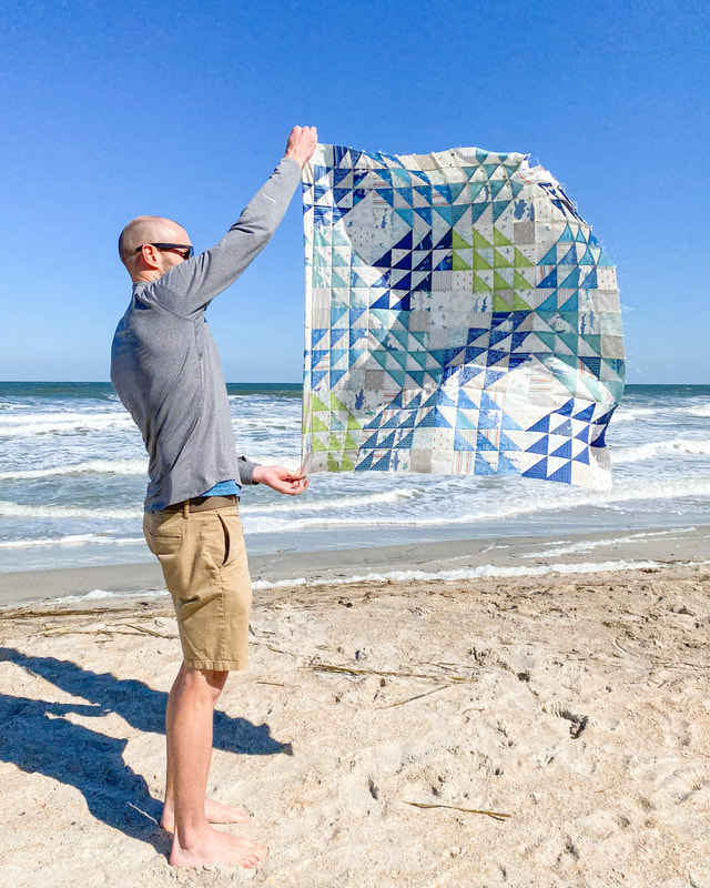 man holding ocean waves quilt
